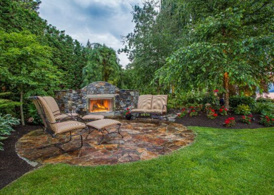 wellness landscaping kelowna with natural flagstone sitting area with fire feature
